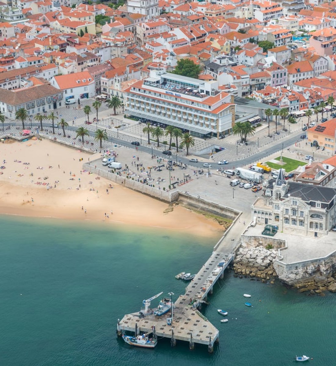 The beach, promenade and pier in the centre of Cascais from above